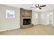 Spacious living room featuring a cozy stone fireplace and large windows for ample natural light at 5015 Nowland Ave, Indianapolis, IN 46201