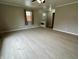 This living room has laminate flooring, neutral paint, and ample natural light at 5015 Nowland Ave, Indianapolis, IN 46201