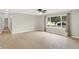 Bright living room featuring hardwood floors, ceiling fan, and large window overlooking the yard at 5015 Nowland Ave, Indianapolis, IN 46201