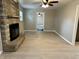 Spacious living room featuring light hardwood floors and a stone fireplace at 5015 Nowland Ave, Indianapolis, IN 46201
