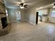 Open living room featuring hardwood floors, a ceiling fan and a stone fireplace at 5015 Nowland Ave, Indianapolis, IN 46201