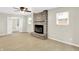 Bright living room featuring a stone fireplace and two large windows for ample natural light at 5015 Nowland Ave, Indianapolis, IN 46201