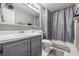 Bathroom featuring gray cabinetry, updated fixtures, and a shower with curtain at 5305 Traditions Rd, Indianapolis, IN 46235