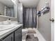 Bathroom featuring gray cabinetry, updated fixtures, and a shower with curtain at 5305 Traditions Rd, Indianapolis, IN 46235