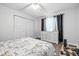 Bedroom with white walls, wood-look flooring, and a closet for storage at 5305 Traditions Rd, Indianapolis, IN 46235