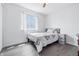 Bright bedroom with wood-look flooring and a window letting in natural light at 5305 Traditions Rd, Indianapolis, IN 46235