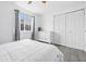 Bedroom with gray wood-look flooring, and a double door closet at 5305 Traditions Rd, Indianapolis, IN 46235