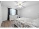 Bright bedroom featuring a ceiling fan, neutral walls, and hardwood floors at 5305 Traditions Rd, Indianapolis, IN 46235