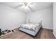 Bright bedroom featuring wood-look flooring, a ceiling fan, and neutral decor at 5305 Traditions Rd, Indianapolis, IN 46235