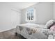 Cozy bedroom with wood-look floors, and a double door closet at 5305 Traditions Rd, Indianapolis, IN 46235