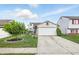 Charming two-story home with a well-manicured lawn, two-car garage and a lovely tree at 5305 Traditions Rd, Indianapolis, IN 46235