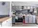Modern kitchen features updated appliances, cabinets, tile backsplash and a white island at 5305 Traditions Rd, Indianapolis, IN 46235