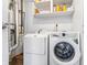 Laundry room with white washer and dryer units, and built-in shelving at 5305 Traditions Rd, Indianapolis, IN 46235