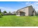 Expansive backyard with lush green lawn, screened-in porch, and vinyl siding in a well-maintained outdoor space at 5519 Apple Branch Way, Indianapolis, IN 46237