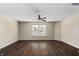 Spacious bedroom featuring hardwood floors, a ceiling fan, and natural light from large windows at 5519 Apple Branch Way, Indianapolis, IN 46237