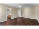 Bedroom featuring hardwood floors, natural lighting from windows, and neutral walls with ensuite at 5519 Apple Branch Way, Indianapolis, IN 46237