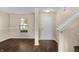 Bright entryway featuring dark wood-look floors, a white door, and a view of the front yard through the window at 5519 Apple Branch Way, Indianapolis, IN 46237