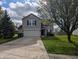 Charming two-story home with a well-maintained lawn, inviting curb appeal, and attached two car garage at 5519 Apple Branch Way, Indianapolis, IN 46237