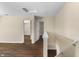 Bright upstairs hallway with hardwood floors, white trim, and multiple doorways at 5519 Apple Branch Way, Indianapolis, IN 46237