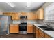 Functional kitchen with stainless steel appliances, wooden cabinets, and ample counter space for meal preparation at 5519 Apple Branch Way, Indianapolis, IN 46237