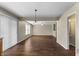 Open living space featuring dark wood-look floors, a ceiling fan, and access to other living areas at 5519 Apple Branch Way, Indianapolis, IN 46237