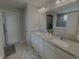 A bright bathroom features a dual sink vanity with granite counters and a view of the walk-in shower at 5527 Mahogany Dr, Noblesville, IN 46062