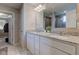 A bathroom features a dual sink vanity with granite counters and a view of the walk-in shower at 5527 Mahogany Dr, Noblesville, IN 46062