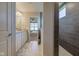 A bathroom showcases a dual sink vanity with granite countertops and a tiled walk-in shower at 5527 Mahogany Dr, Noblesville, IN 46062