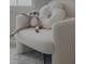 A cozy bedroom with a teddy bear and decorative pillow in a comfy chair at 5527 Mahogany Dr, Noblesville, IN 46062