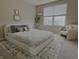 A bedroom features a plush bed, stuffed animals, neutral decor, and a bright window at 5527 Mahogany Dr, Noblesville, IN 46062