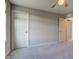 Carpeted bedroom featuring two doors and a ceiling fan at 5527 Mahogany Dr, Noblesville, IN 46062