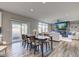 Dining area with a sliding glass door, stylish floors, and an open view of the living room at 5527 Mahogany Dr, Noblesville, IN 46062