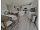 Bright dining area showcasing wood-look flooring and seamless access to a modern kitchen at 5527 Mahogany Dr, Noblesville, IN 46062