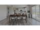 Open-concept dining area with kitchen views, plenty of seating, and modern wood-look flooring at 5527 Mahogany Dr, Noblesville, IN 46062