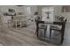 Dining space featuring a dark wood table, seating for eight, and a view to the kitchen at 5527 Mahogany Dr, Noblesville, IN 46062