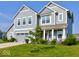 Beautiful two-story home featuring light-blue siding, a two-car garage, and a lush green lawn at 5527 Mahogany Dr, Noblesville, IN 46062