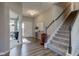 Open entryway with wood-look flooring, stairs to the second floor, and a welcoming front door at 5527 Mahogany Dr, Noblesville, IN 46062