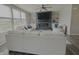 Bright living room with modern fireplace, built-ins, ceiling fan, and large windows for natural light at 5527 Mahogany Dr, Noblesville, IN 46062