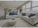 Cozy living room with plush sofas, stylish pillows, and large windows flooding the space with light at 5527 Mahogany Dr, Noblesville, IN 46062