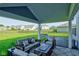 Relaxing covered patio with comfortable seating and views of the spacious backyard at 5527 Mahogany Dr, Noblesville, IN 46062