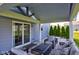 Covered patio area featuring comfortable outdoor seating and a modern fire pit table at 5527 Mahogany Dr, Noblesville, IN 46062