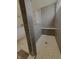 A modern shower features gray tiles, a built-in bench, and a textured tile floor at 5527 Mahogany Dr, Noblesville, IN 46062
