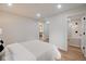 Bright bedroom with an open doorway to the bathroom featuring neutral walls and hardwood floors at 555 N Oakland Ave, Indianapolis, IN 46201
