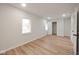 Open bedroom with windows and hardwood floors featuring neutral walls at 555 N Oakland Ave, Indianapolis, IN 46201