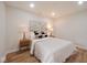 Comfortable bedroom featuring hardwood floors, accent wall art and decorative pillows at 555 N Oakland Ave, Indianapolis, IN 46201
