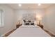 Bright bedroom with a comfortable bed, hardwood floors, and decorative lamps at 555 N Oakland Ave, Indianapolis, IN 46201