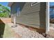 Exterior of the home, showcasing the siding and rock landscaping around the foundation at 555 N Oakland Ave, Indianapolis, IN 46201
