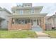 Charming two-story home with a welcoming front porch and brick accents at 555 N Oakland Ave, Indianapolis, IN 46201