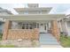 Charming two-story home with a welcoming front porch and brick accents at 555 N Oakland Ave, Indianapolis, IN 46201