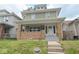 Charming home with a brick-accented porch and a freshly painted white front door, creating a welcoming curb appeal at 555 N Oakland Ave, Indianapolis, IN 46201